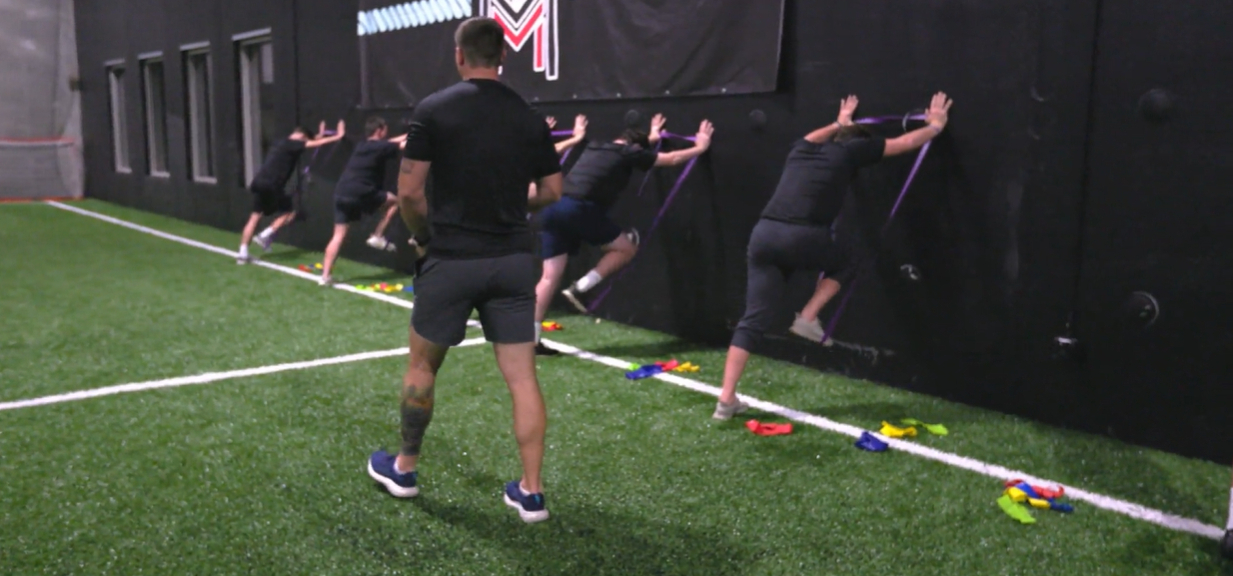 Francis Mulkern coaching athletes through resisted sprint drills